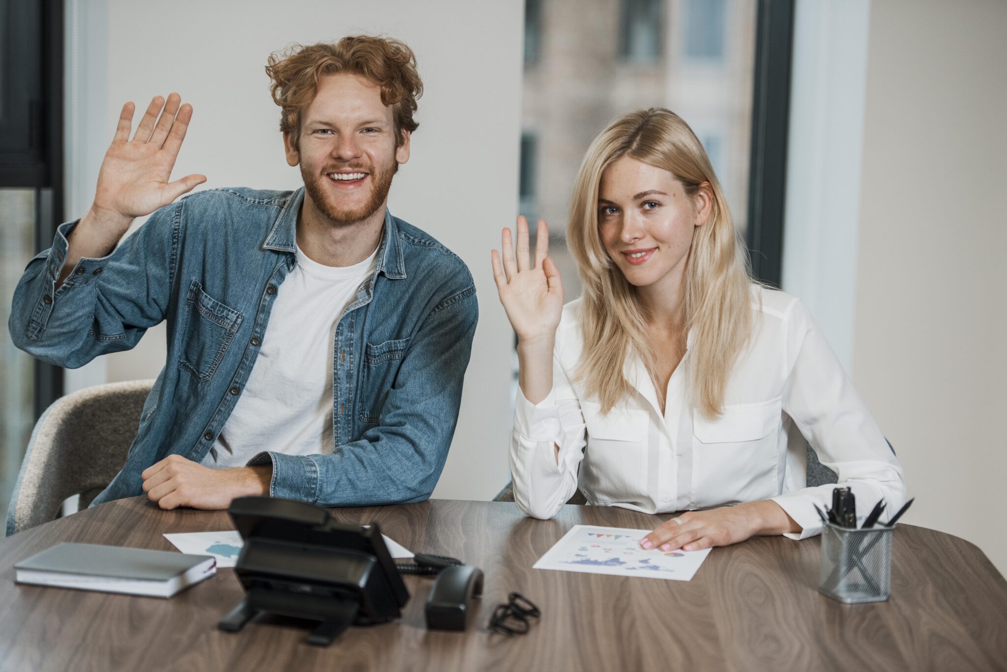 job colleagues waving with their hands 2048x1367 1